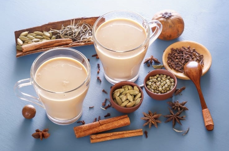 Masala chai with whole spices around